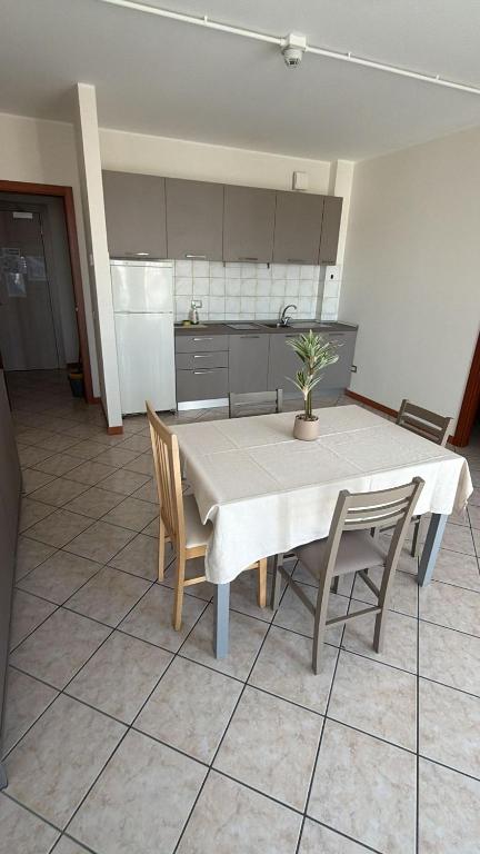 a kitchen with a table and chairs in a room at Savi Residence in Savigliano