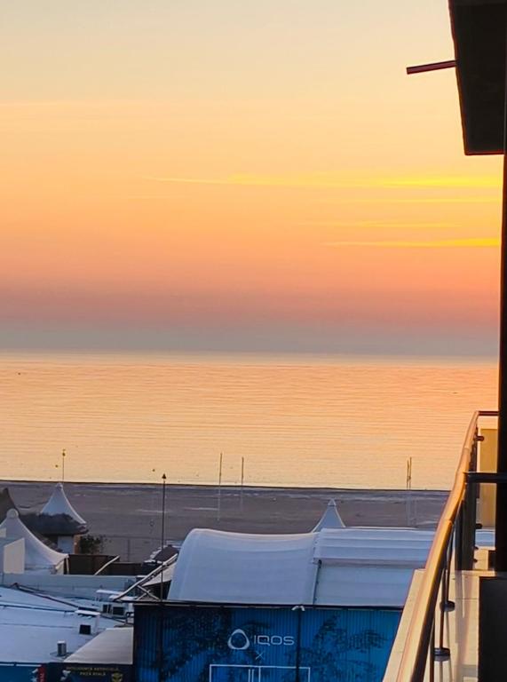 a view of the ocean at sunset from a balcony at SeaLaVie - Summerland Mamaia in Mamaia