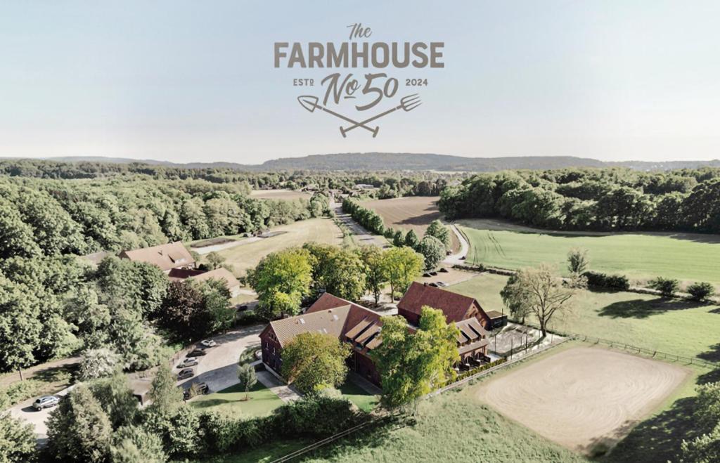 an aerial view of a farm house with a golf course at Hotel the Farmhouse No 50 - kostenfreies Parken! - Cafe & Eventrooms in Osnabrück