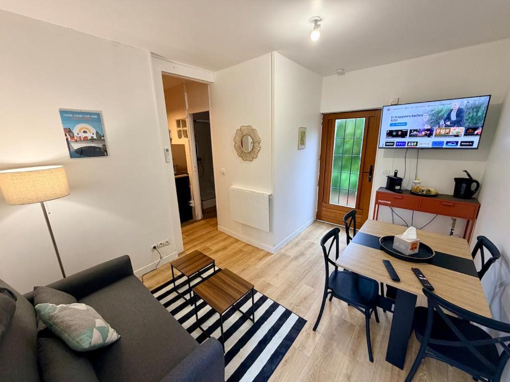 a living room with a couch and a table at Maisonnette en coeur de ville in Cosne-Cours-sur-Loire
