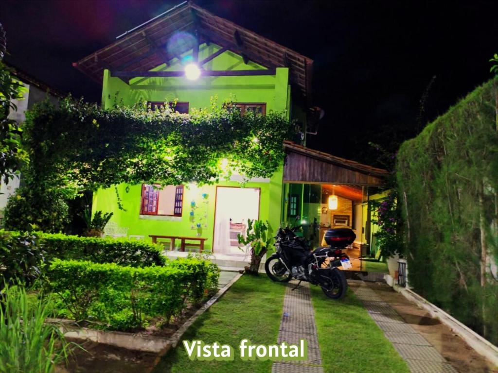 a motorcycle parked in front of a house at night at Chalé Esmeralda in Gravatá