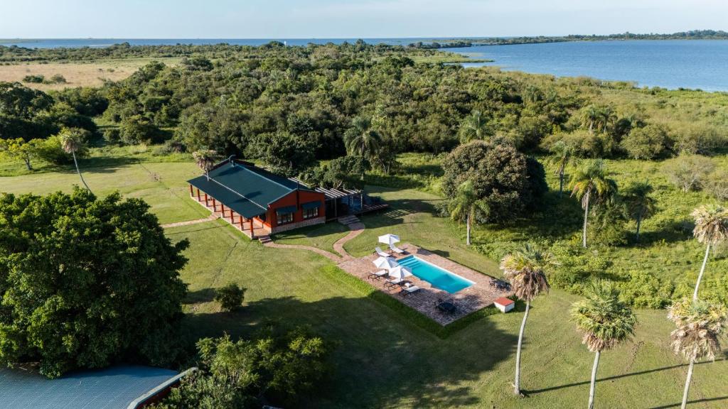 an aerial view of a house with a swimming pool at Estancia Iberá in Colonia Carlos Pellegrini
