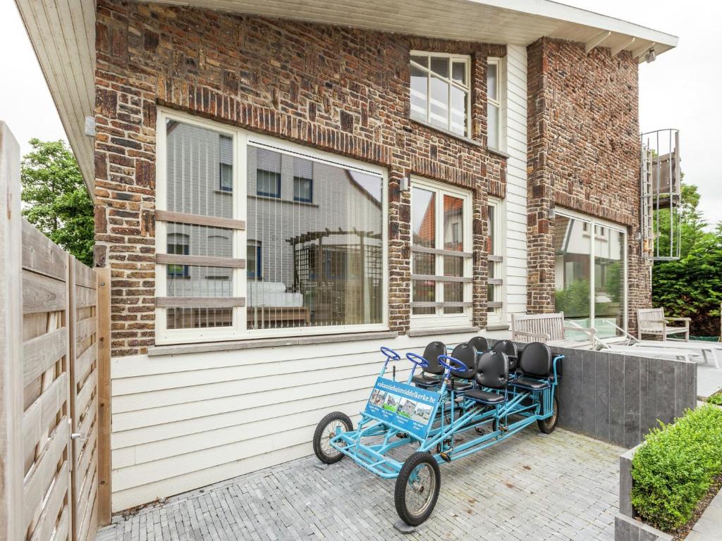 a blue cart parked in front of a house at Villa with jacuzzi & sauna 500m from beach in Middelkerke