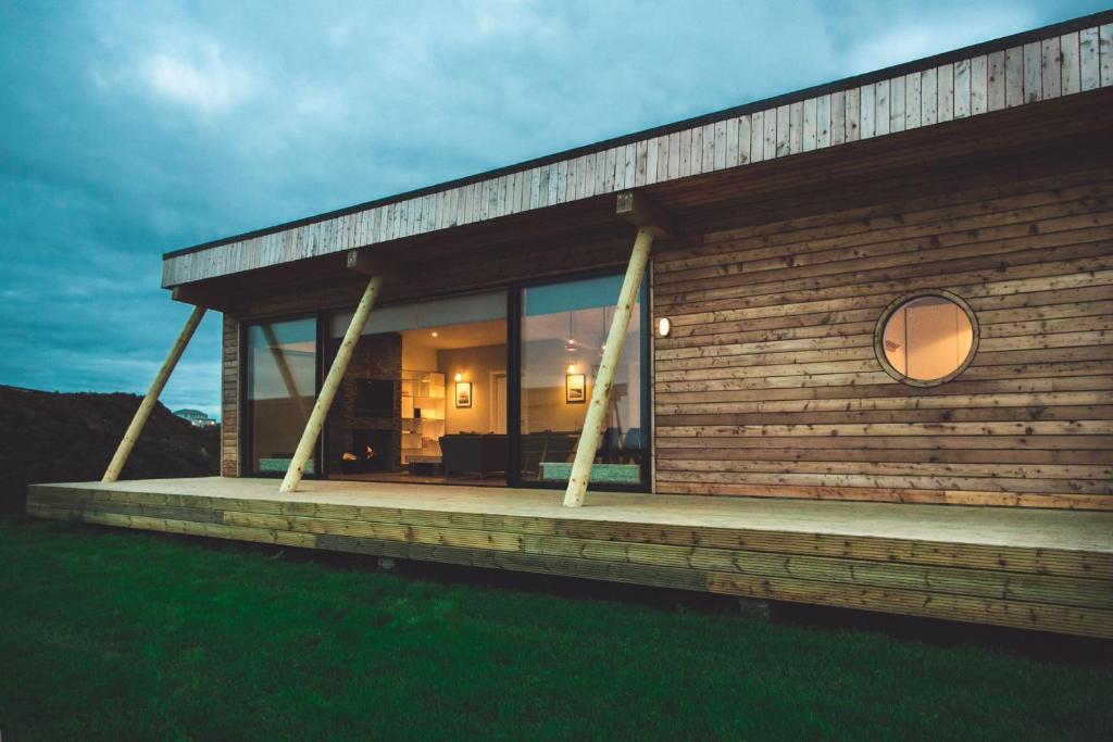 a house with a large window on the side of it at Jog Lodge 22 By Together Travel - 3 Bed Sea-View in Wick