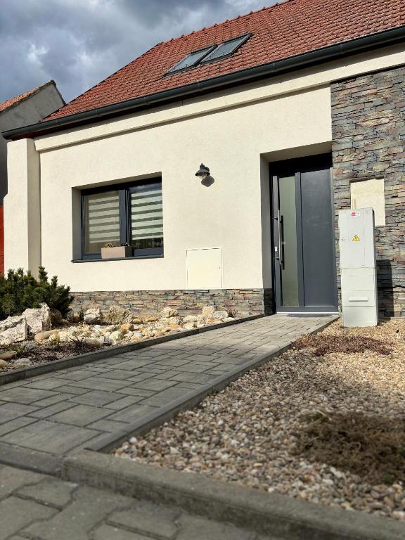 a house with a door on the side of it at Apartmán U Štýbnarů in Bulhary