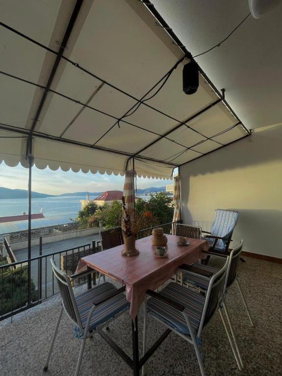 a table and chairs on a balcony with a view at Apartment Mladinić in Okrug Donji