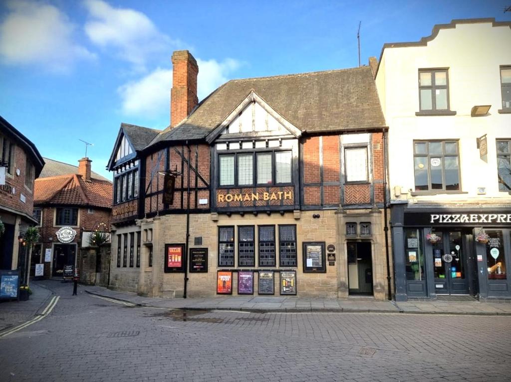 an old building on the corner of a street at The Roman Bath in York