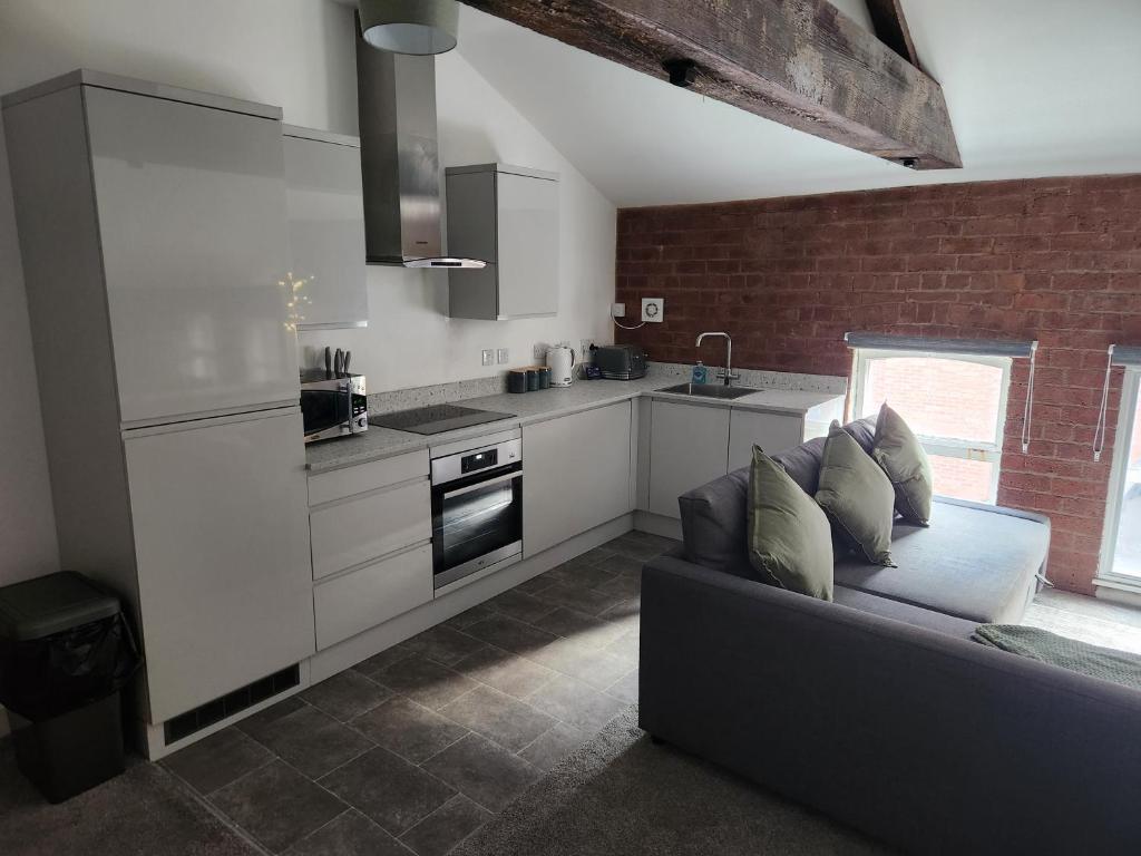 a living room with a couch and a kitchen at C&B Holdings in Hull