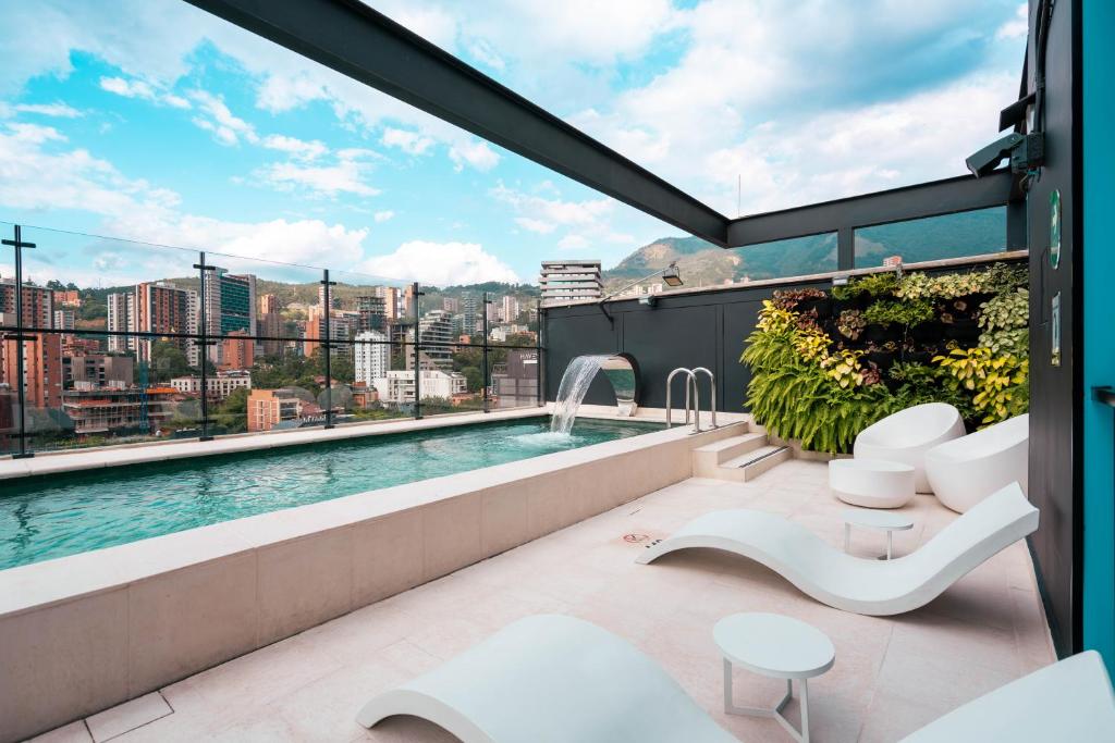 a view from the balcony of a building with a swimming pool at Calle Flora Hotel by Jalo in Medellín