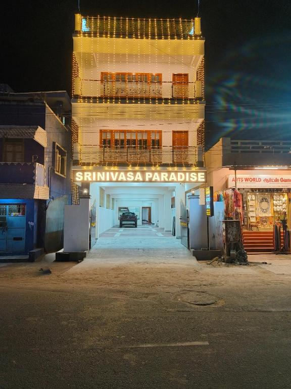 a building with a parking garage in front of it at Srinivasa Paradise in Mahabalipuram