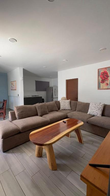 a living room with a couch and a wooden coffee table at Hotel Luz de Luna y Villas in San Jerónimo