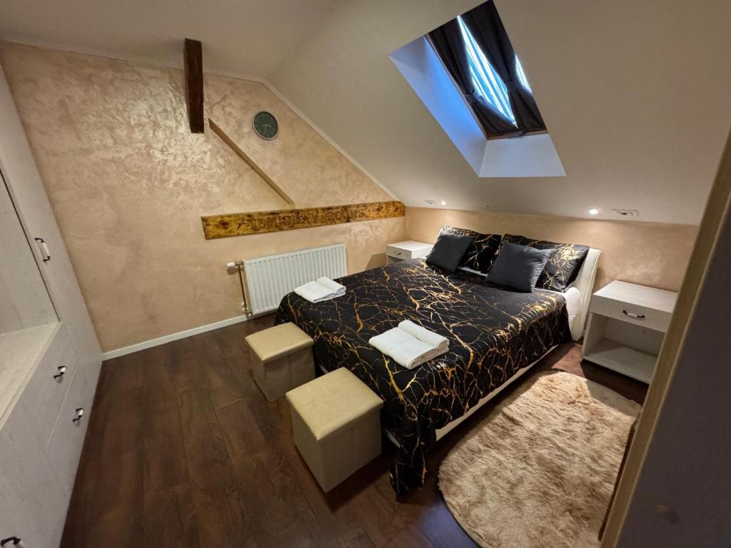a bedroom with a bed and a skylight at TOMISLAV in Zagreb