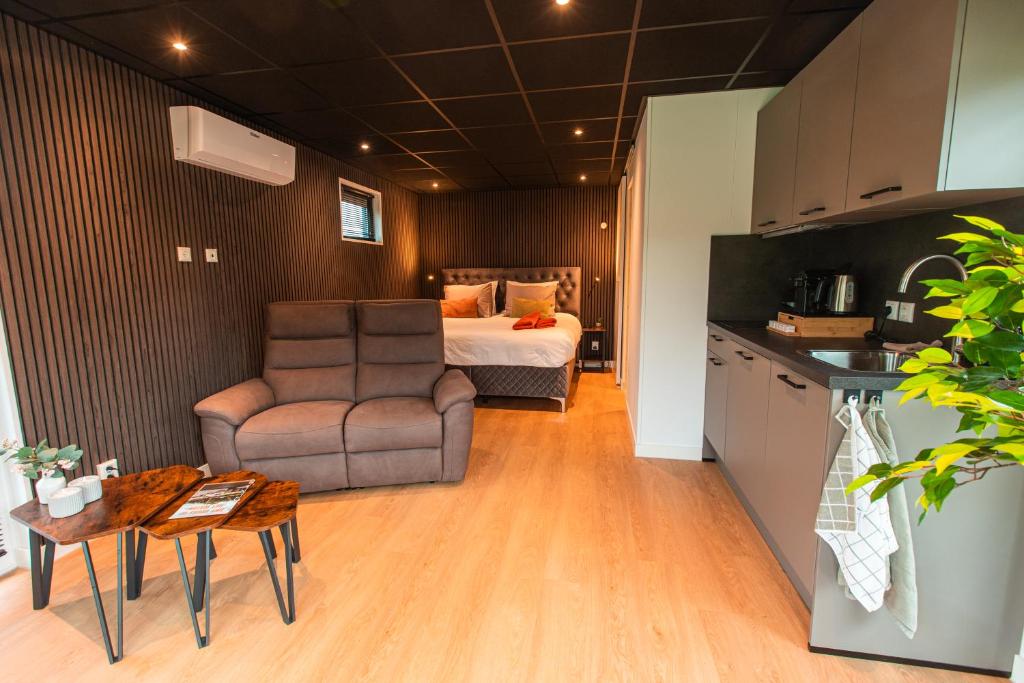 a bedroom with a bed and a chair and a table at Tiny boat house #2 in Garnwerd