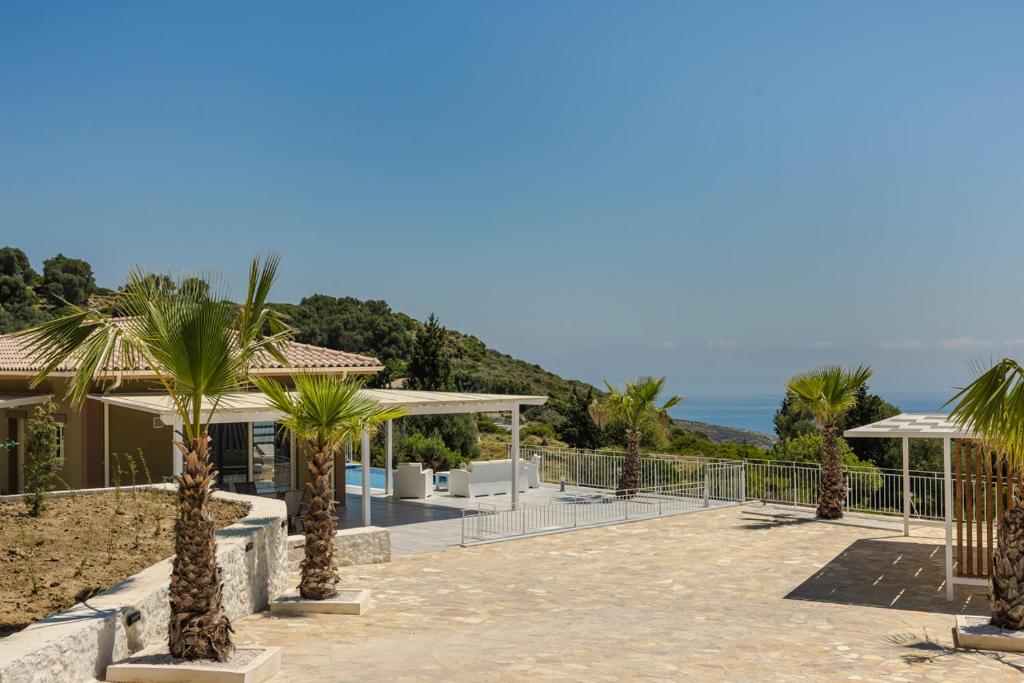 a view of a house with palm trees at Saint Nicholas Villas 5 in Skala