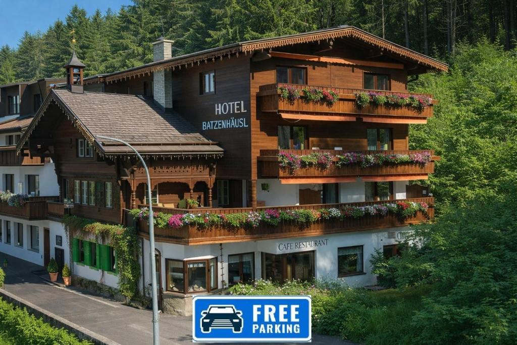 a hotel with a free parking sign in front of it at Hotel Batzenhäusl in Innsbruck