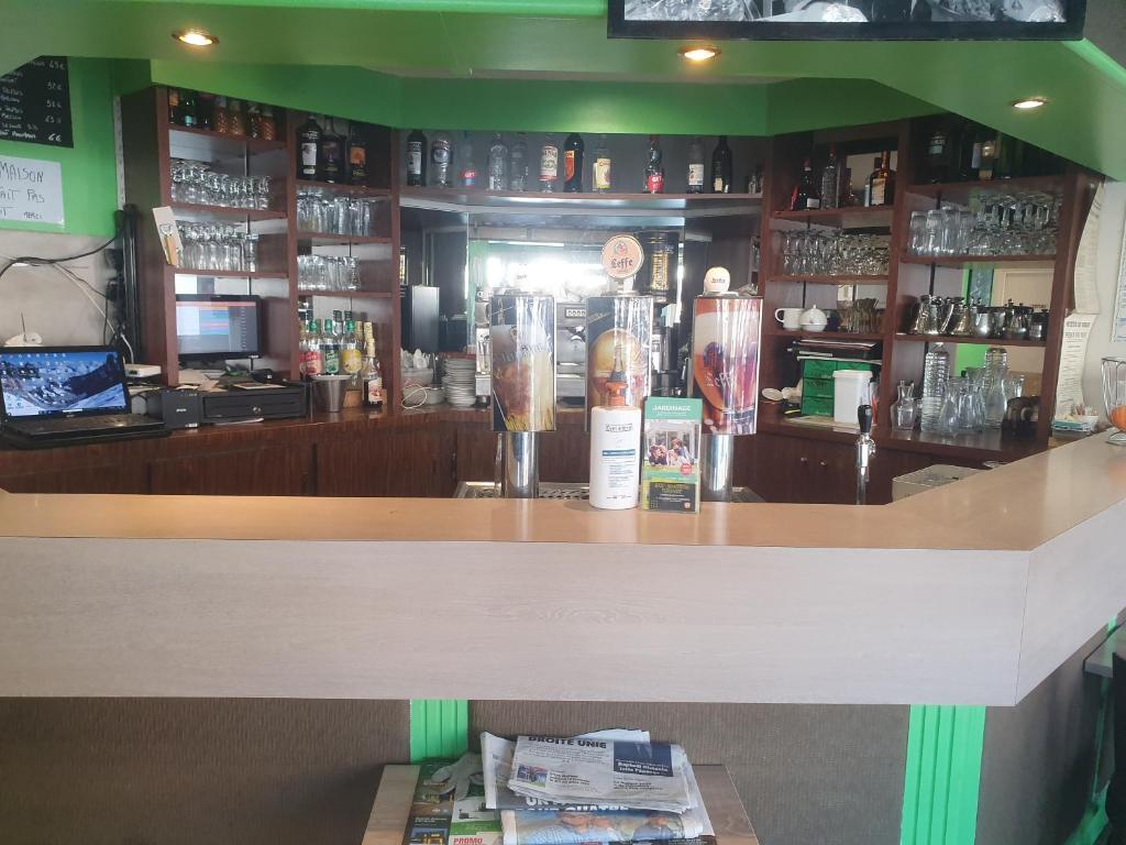 a bar in a restaurant with a counter at Hôtel de la poste in La Celle-sous-Gouzon