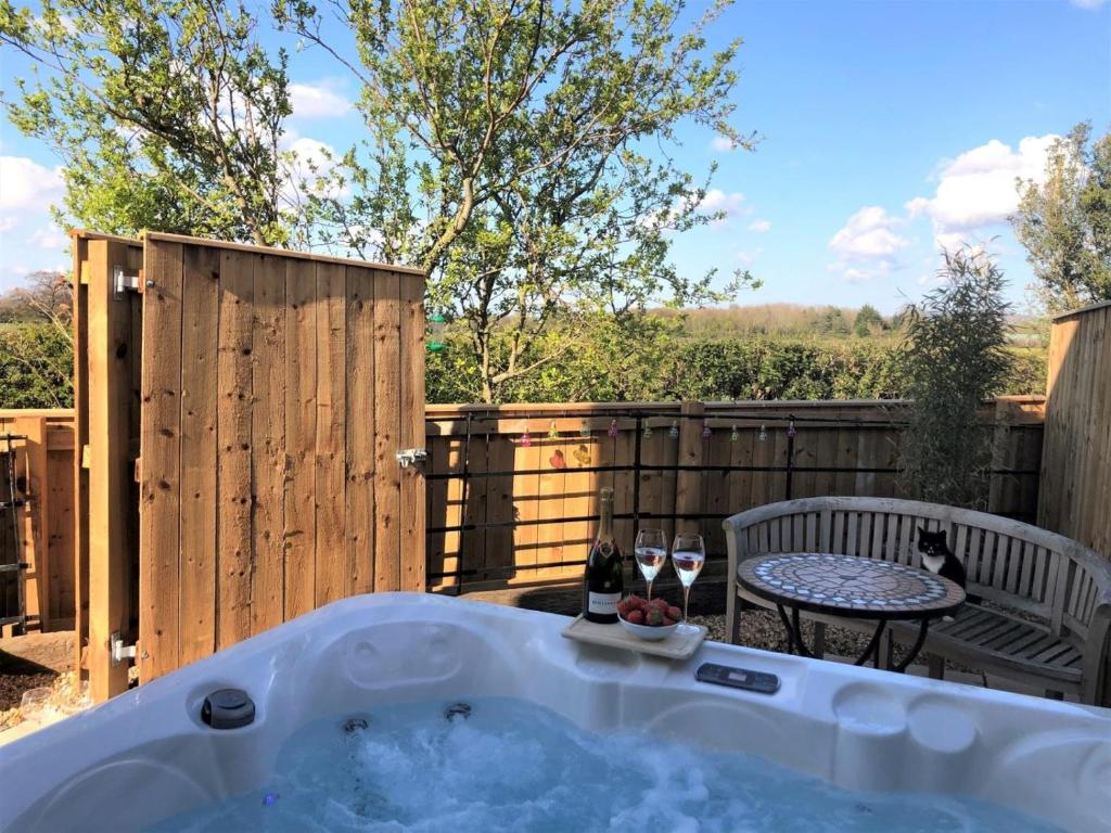 a hot tub in a backyard with a table and chairs at 2 Bed in Stokesley oc-g0072 in Carlton