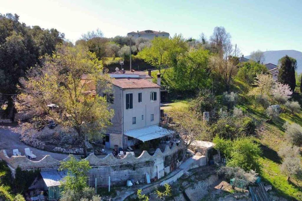 an aerial view of a house in the woods at Antico Leccio Green in Coppe