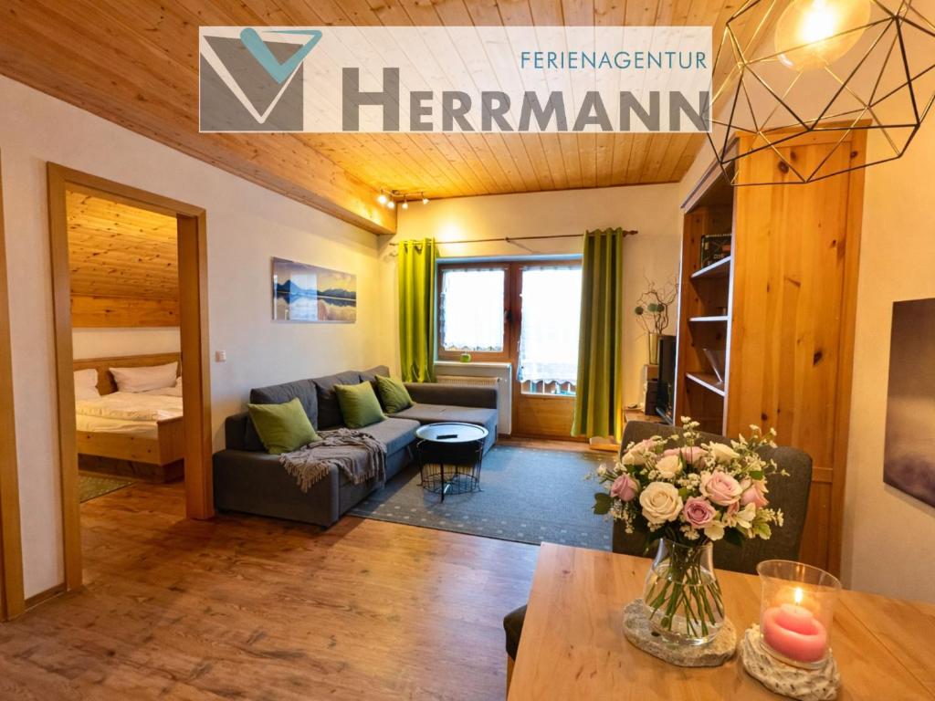 a living room with a couch and a table at Ferienwohnung Forggensee-Blick in Schwangau