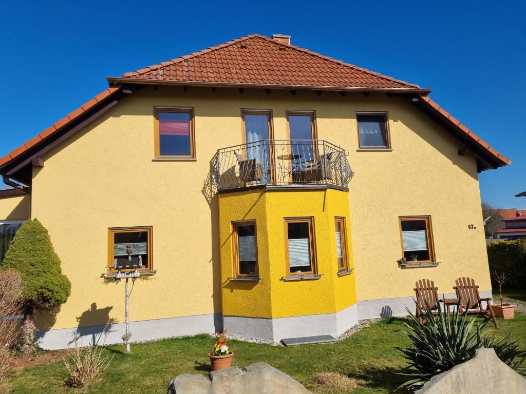a yellow house with a balcony at Zschirnsteinblick in Schöna