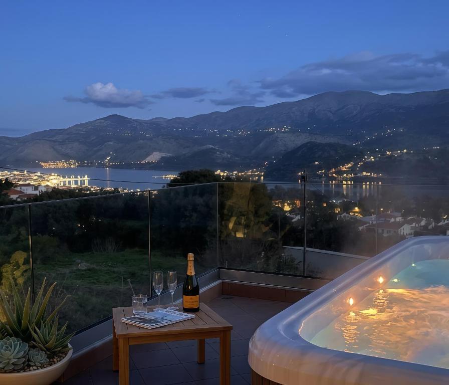 a bottle of wine on a table next to a bath tub at 360 Skyline Suite, Argostoli in Argostoli