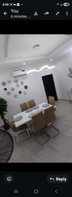 a picture of a living room with a table and chairs at Dvyne Lux Home - Lagos in Ikeja