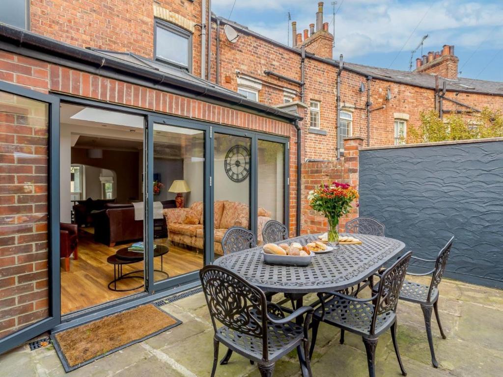 an extension to a brick house with a table and chairs at 4 Bed in Harrogate oc-hh025 in Harrogate