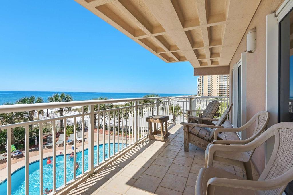 a balcony with a view of the pool and the ocean at Destin Towers 32 in Destin
