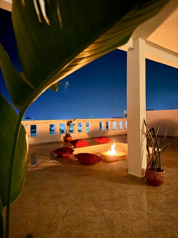 a patio with a fire pit and a building at Hakuna Matata Guest House in Tamraght Ouzdar