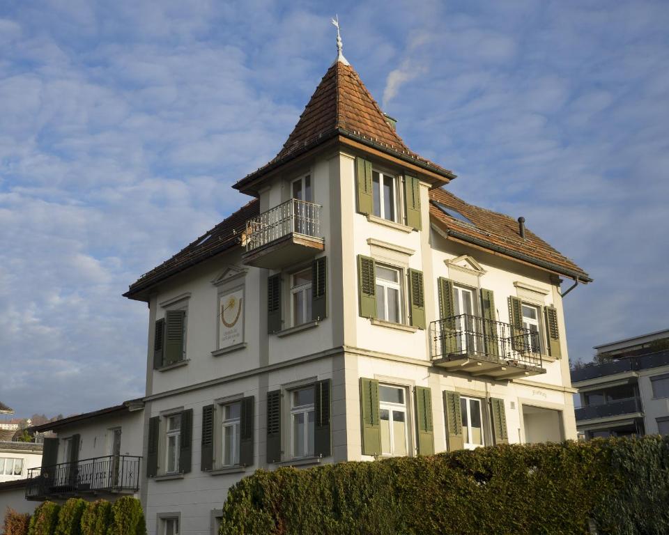 a large white building with a tower on top of it at Studio Frohburg Gommiswald in Gommiswald