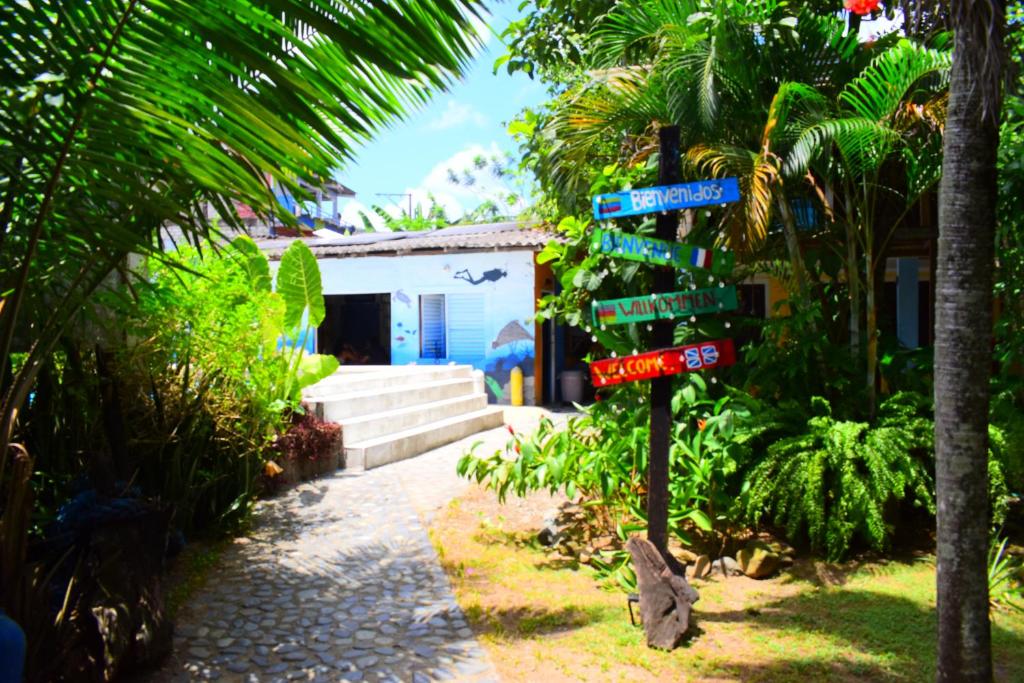a street sign with street signs in front of a building at Dive and Green Capurgana in Capurganá