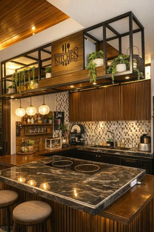 a kitchen with a counter with a stove top oven at Jhenk's Guesthouse in Coleto