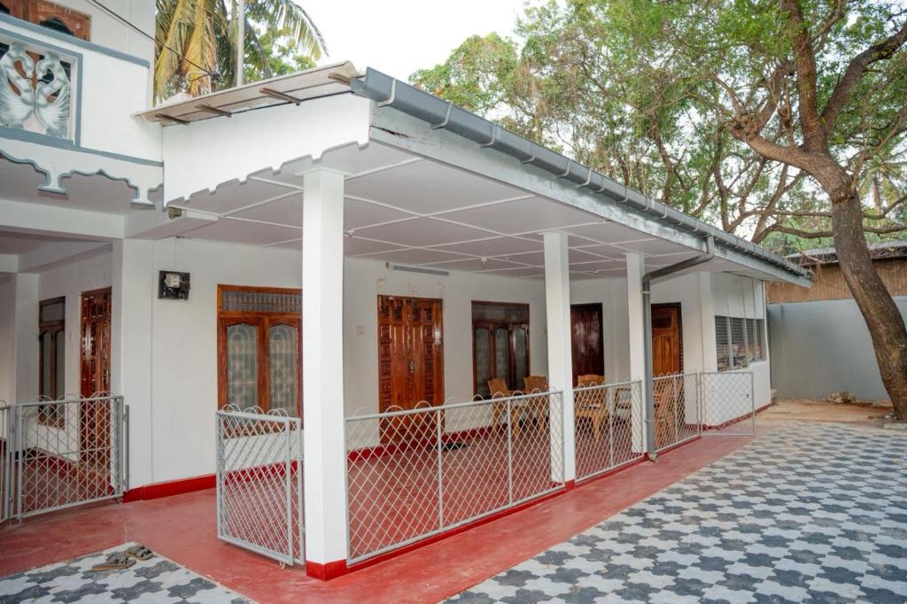 a view of the front of a house with a tree at lagoon holiday villa Jaffna in Tavadi