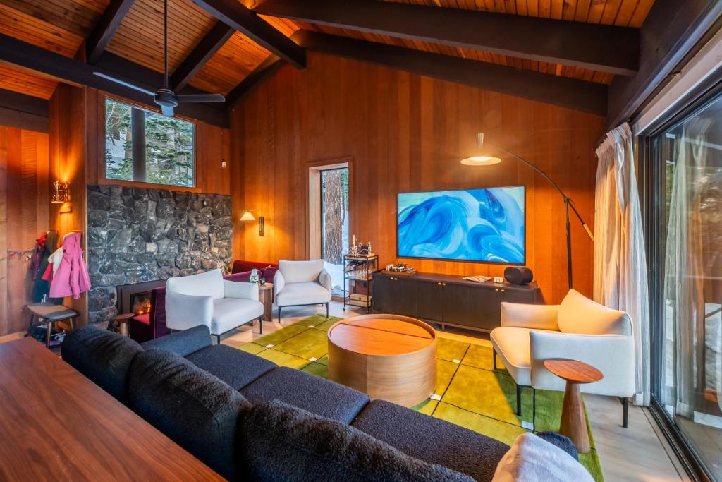 a living room with a couch and a tv at The Icelander at Mammoth Point in Mammoth Lakes