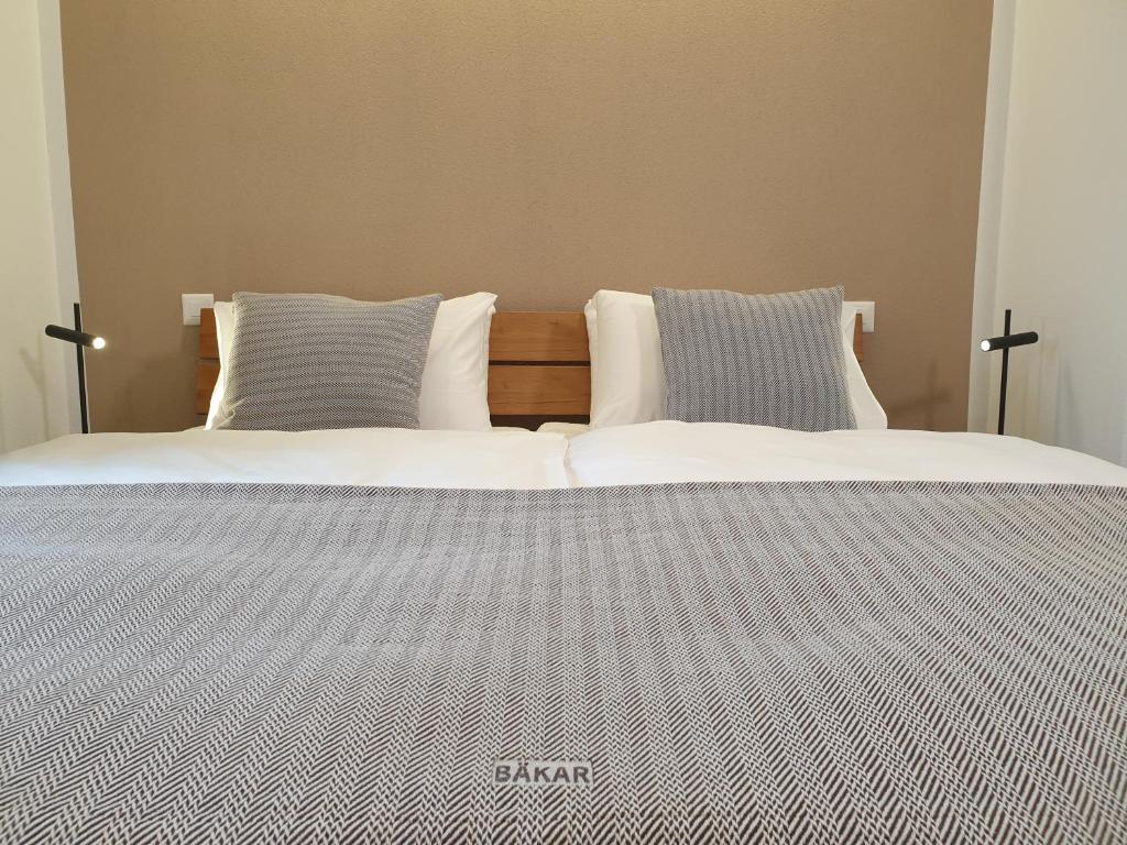 two beds sitting next to each other in a bedroom at Camere Osteria Bäkar, Val Bedretto in Bedretto