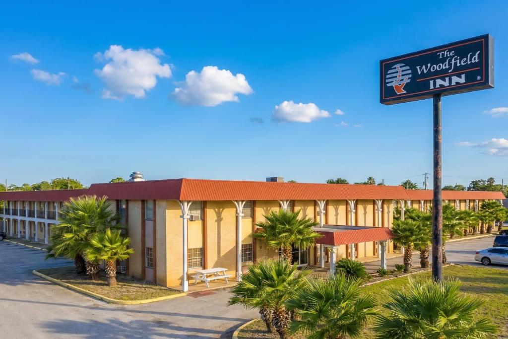 a hotel with a sign in front of it at Woodfield Inn & Suites Hotel O, Yoakum TX 111 in Yoakum
