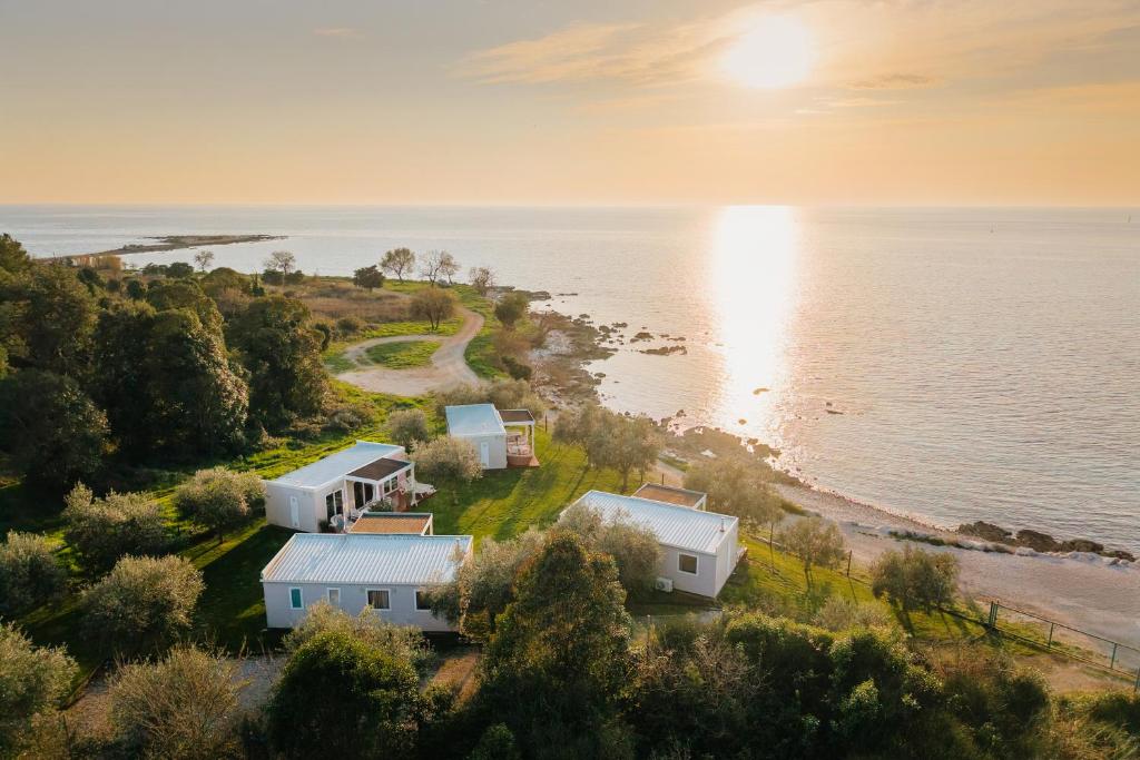 an aerial view of houses on the shore of the water at Mobile Homes Sunset Beach in Umag