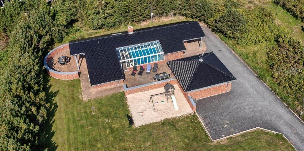 an overhead view of a house with a swimming pool at VE400-Vejers-Strand-Engesovej-52 in Vejers Strand