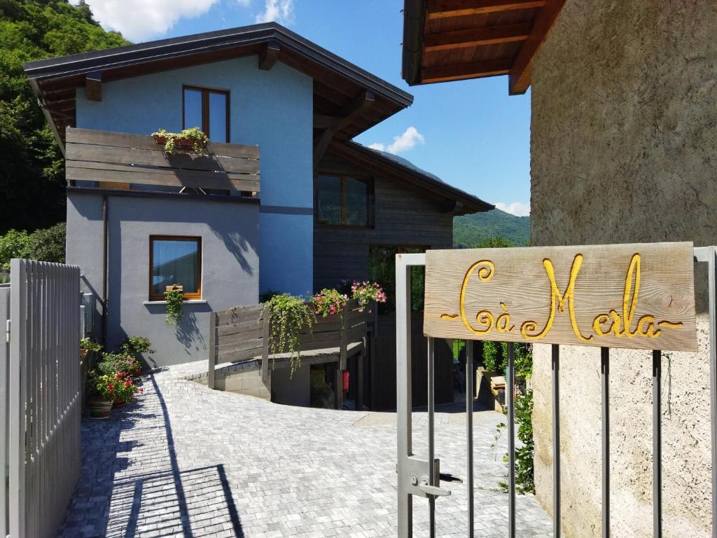 a house with a sign in front of it at Ca' Merla affittacamere in Morbegno