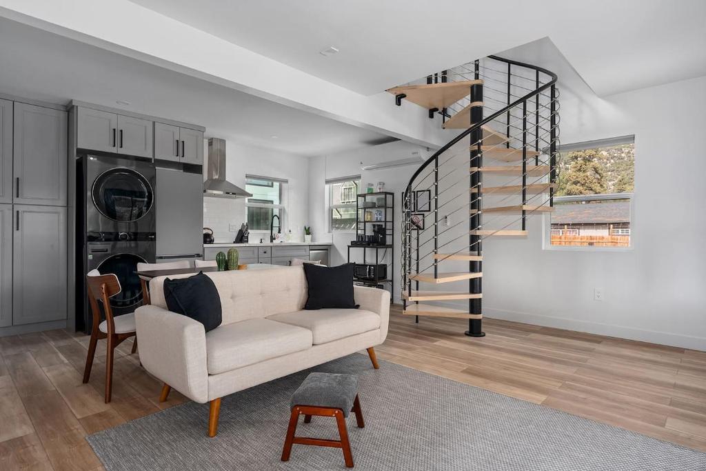 a living room with a couch and a spiral staircase at Spacious w/ 2BR 1Bath - Big Bear in Big Bear City