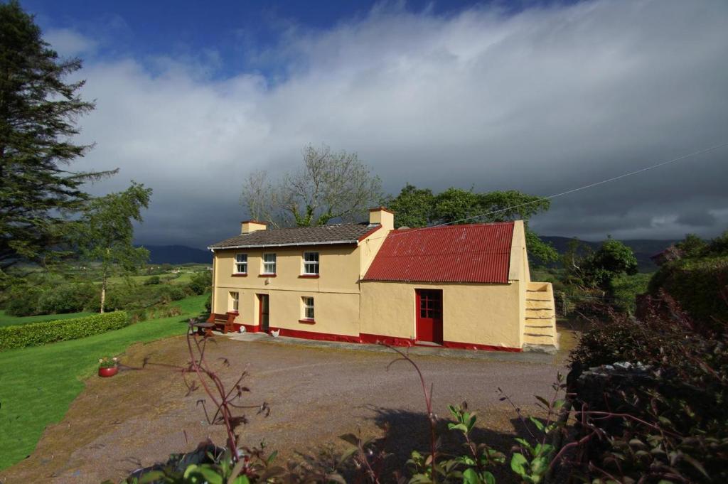 a house with a red roof on a dirt road at 3 Bed in Sneem oc-i426 in Tullakeel