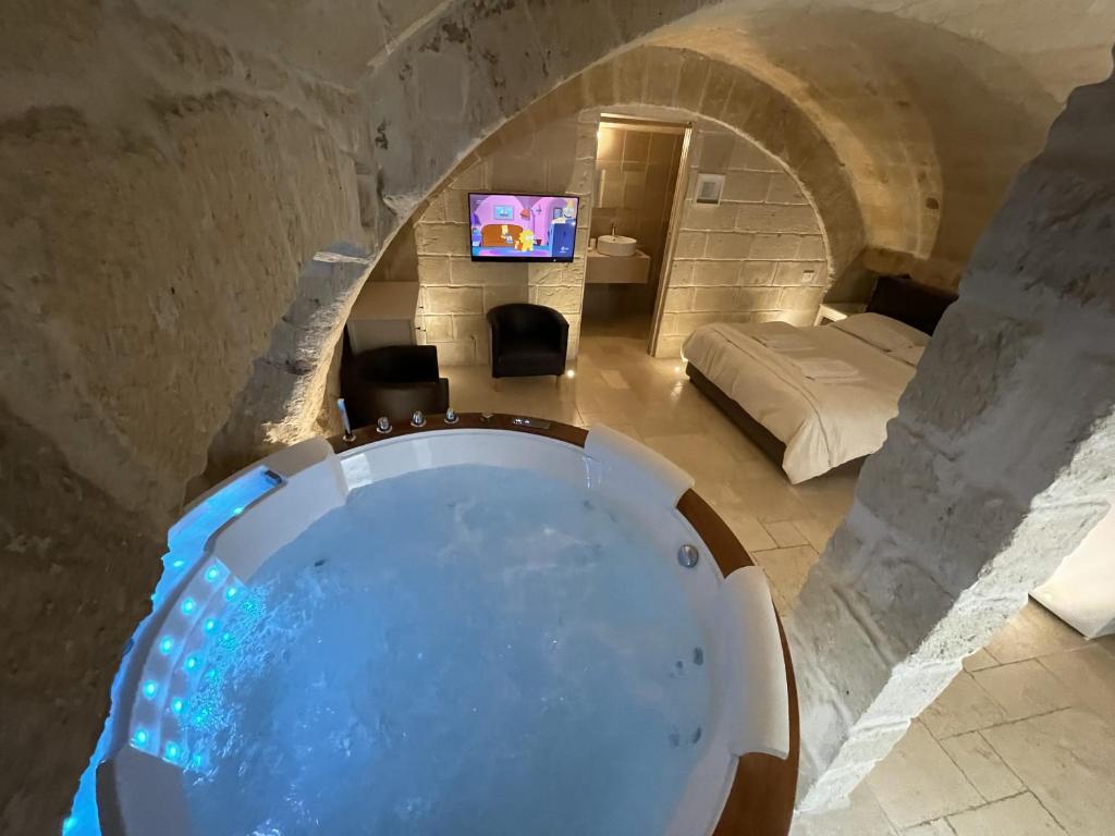 a bathroom with a large tub in a room at Barbacana Monopoli in Monopoli