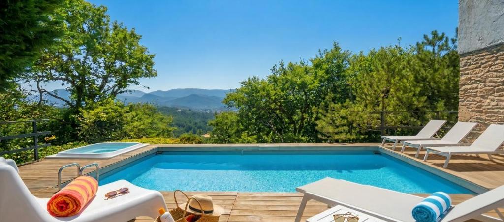a swimming pool with a view of the mountains at villa la chiesetta - private pool and Jacuzzi - Borgo Canapegna in Fabriano