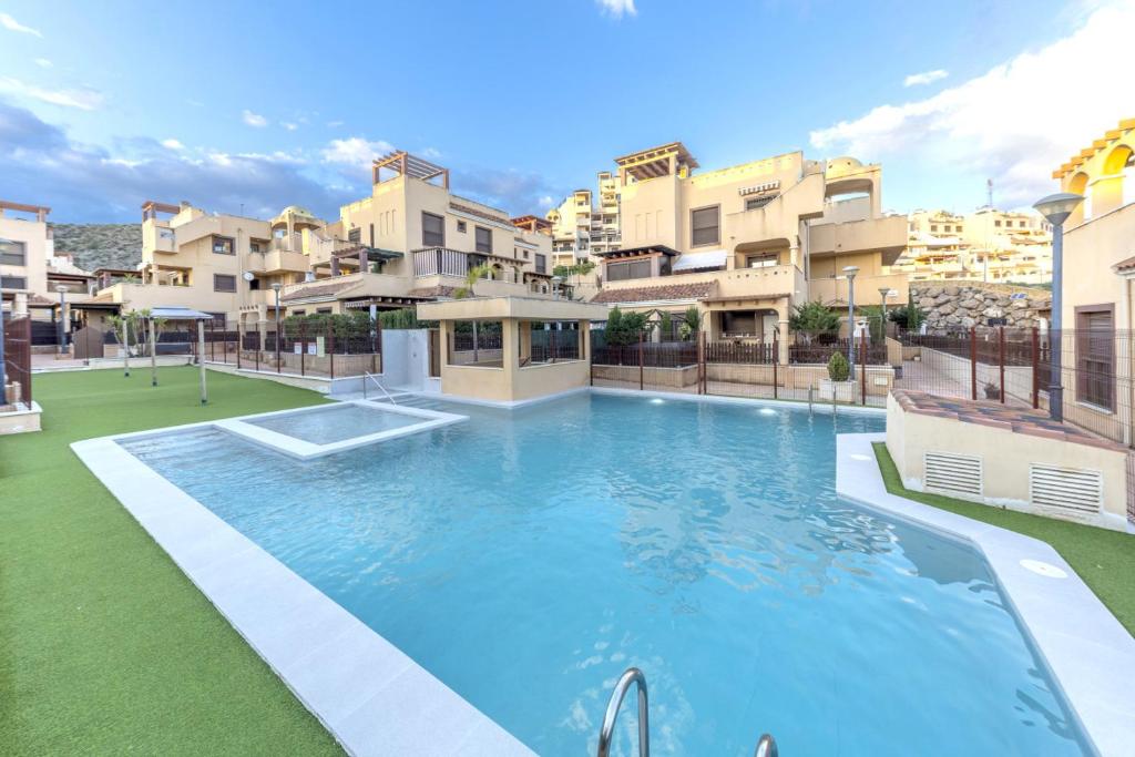 a large swimming pool in front of some buildings at Collados Experience Piscina y Parking in Águilas