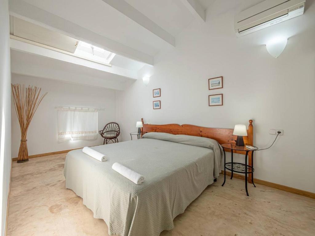 a bedroom with a large bed in a white room at Casa Major by 3VILLAS in Fornells