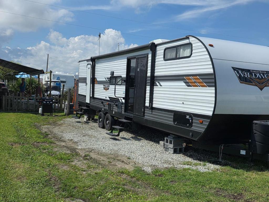 a white and black trailer parked on a gravel road at Catchin Rays in North Topsail Beach