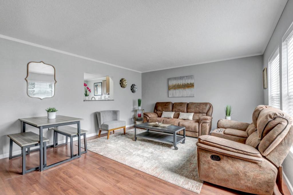 a living room with a couch and a table at Denver Retreat in Arvada