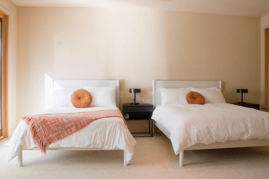 a bedroom with two beds with pillows on them at Quiet Private Room with Ensuite Free Parking in Victoria