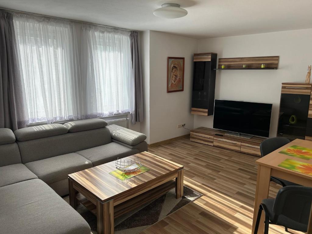 a living room with a couch and a tv at Apartmán Studničky v centre Žiliny in Žilina