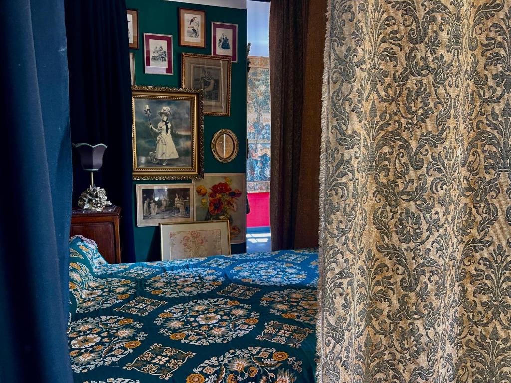 a bedroom with a bed and pictures on the wall at Oranienburg Vintage Hotel - Private Garden Residence in Vianden